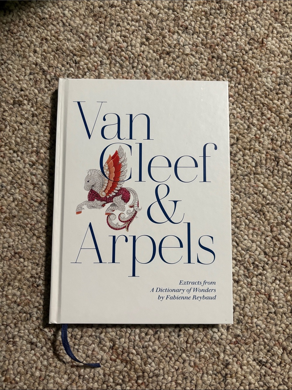 Van Cleef & Arpels White Cover Book with Blue Lettering and Red Accent
